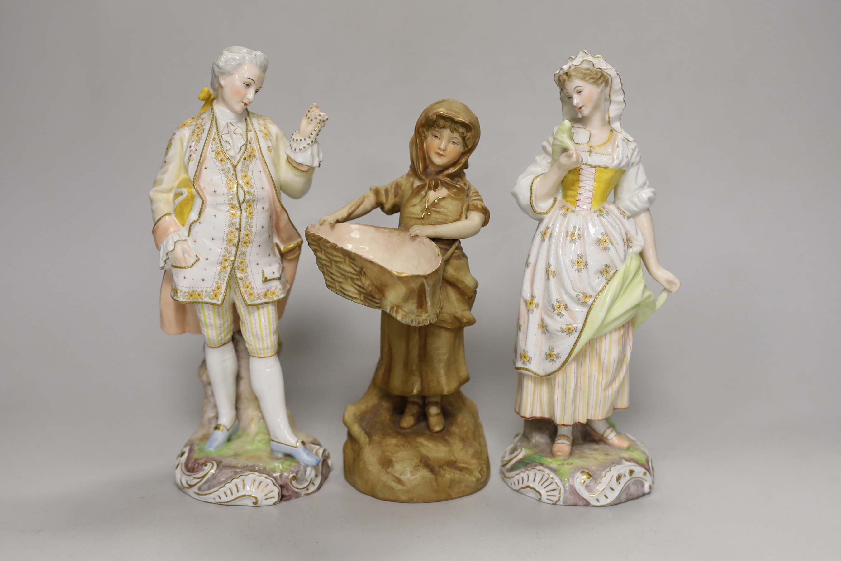 A pair of 19th century German porcelain figures, 22cm, and another